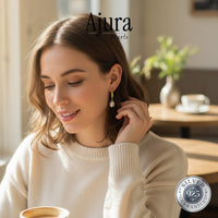 Ajura Pearls 925 sterling silver drop earrings with freshwater pearls and gold detailing. Elegant and timeless.
