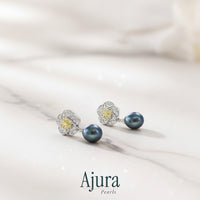 Ajura Pearls black freshwater pearl drop earrings with floral motif and yellow accent stones.