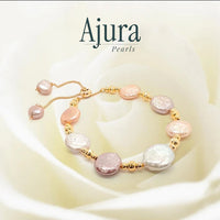 Ajura Pearls bracelet with mixed colour freshwater coin pearls and gold beads. Adjustable slider clasp.