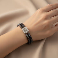 Ajura Pearls dual strand bracelet with black freshwater pearls and a decorative silver clasp.