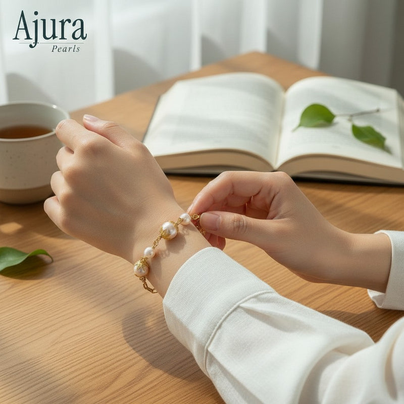 Ajura Pearls bracelet with freshwater pearls and gold-plated chain, featuring decorative gold accents.