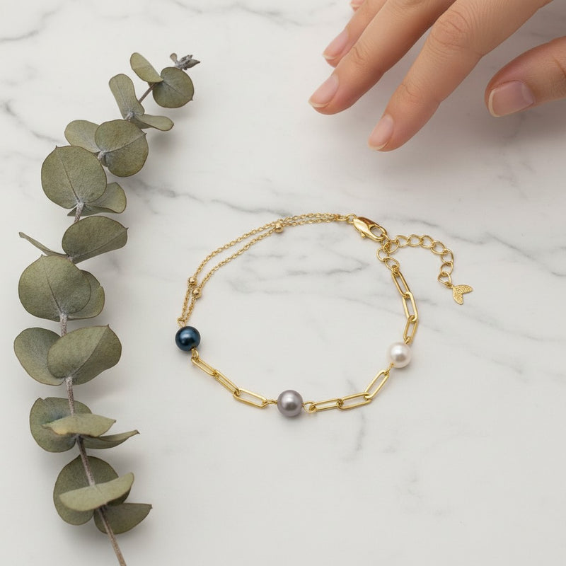 Ajura Pearls gold-plated chain bracelet with freshwater pearls in black, lavender, and white.
