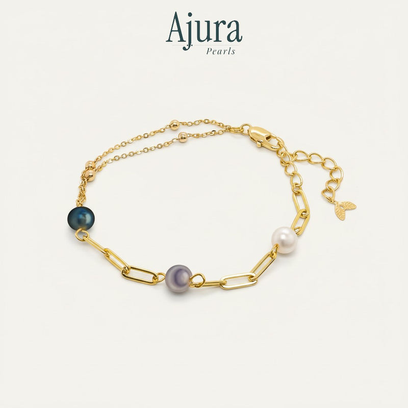 Ajura Pearls gold-plated chain bracelet with three freshwater pearls in white, grey, and dark blue.
