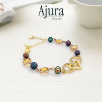 Ajura Pearls bracelet with multi-colored freshwater pearls, citrine-like stones, and interlocking heart charms.