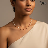 Ajura Pearls delicate necklace with floating baroque freshwater pearls in peach on a near-invisible chain.