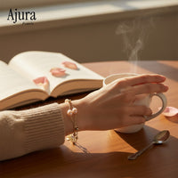 Ajura Pearls delicate bracelet with 6-7mm off-round peach freshwater pearls and gold plated chain.