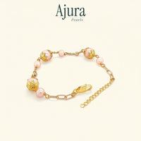 Ajura Pearls peach freshwater potato pearl bracelet with gold-plated filigree beads and chain.