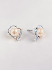 Ajura Pearls peach freshwater pearl stud earrings in sterling silver heart setting with small crystals.
