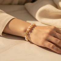 Ajura Pearls peach freshwater pearl bracelet with starfish charm and gold accents.