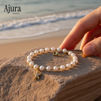 Ajura Pearls white freshwater pearl bracelet with starfish charm and gold beads.