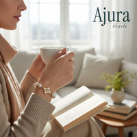 Ajura Pearls white freshwater pearl bracelet with gold clover charm and extension chain.