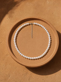 Classic Off Round Pearl Choker — contrasting styled detail