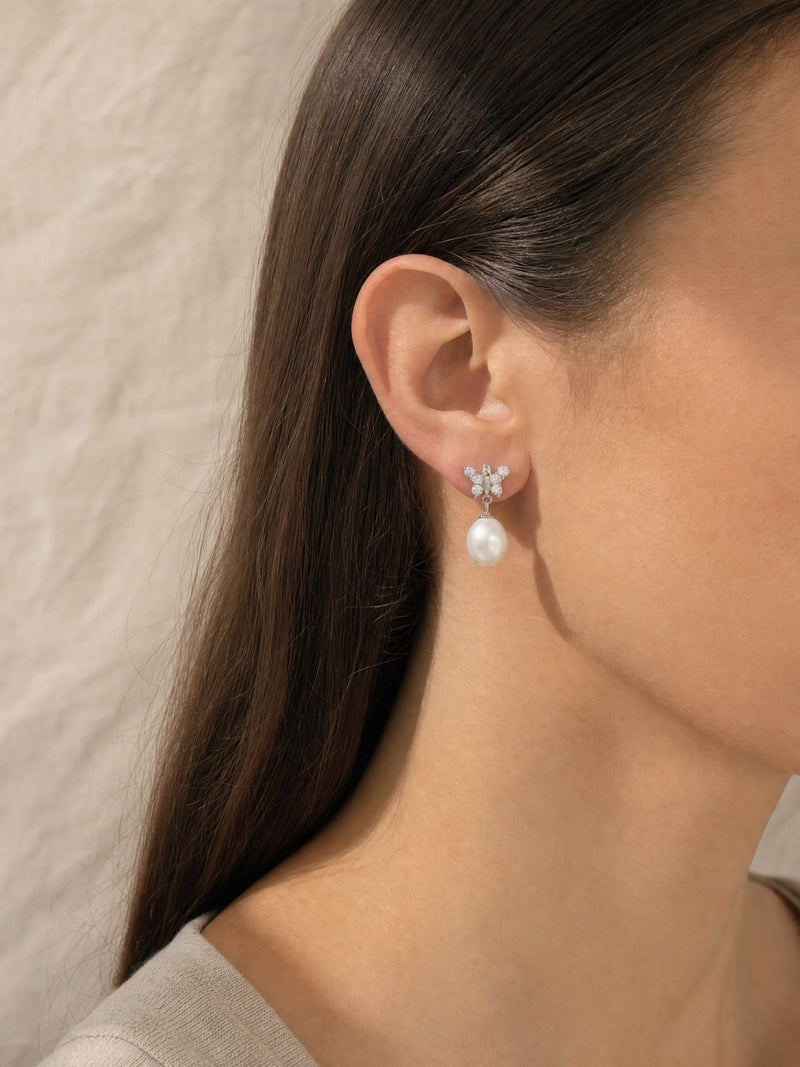 Dainty Butterfly Pearl Earring — worn for scale